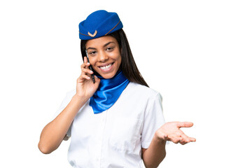 Airplane stewardess African american woman over isolated background keeping a conversation with the...