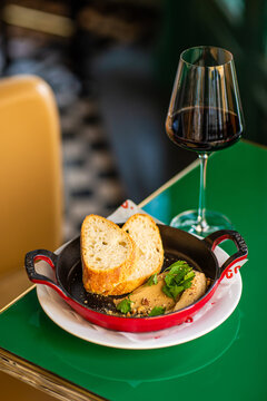 Glass of red wine with hummus and baked bread