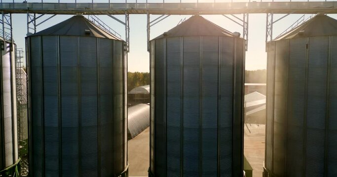 Modern grain silo elevator, view from a height and from different angles. Grain storage tanks on top Grain storage in large cells industrial zone for grain processing silos for agribusiness