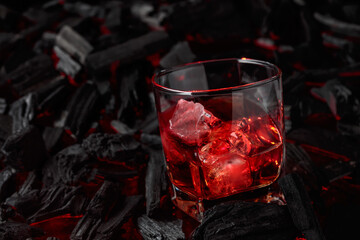  Whiskey with ice  on a background of burning charcoal.