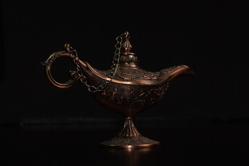 Aladdin's magic lamp isolated on black background