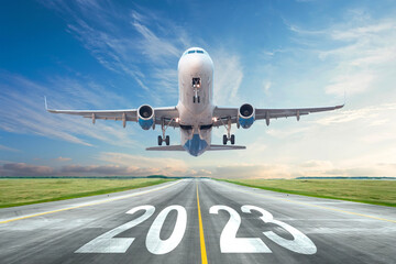 Inscription on the runway 2023 surface of the airport road yellow line take off airplane. Concept...