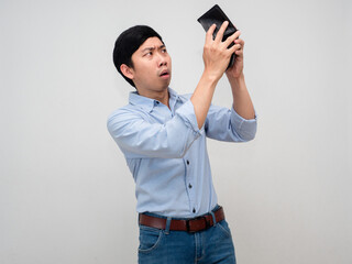Asian businessman blue shirt feels sad gesture find money at his wallet isolated