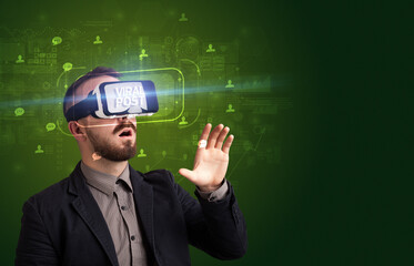 Businessman looking through Virtual Reality glasses, social media concept