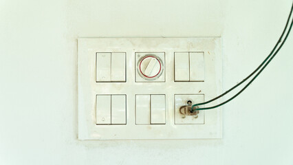 Dust shield with sockets and switches on the street on a white wall, electric