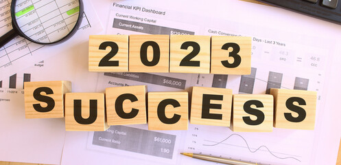 Wooden cubes with letters on the table in the office. Text 2023 SUCCESS.