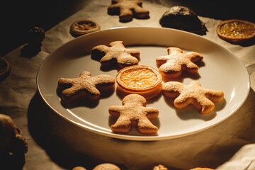 Christmas gingerbread with orange slices, nuts and ginger on baking paper
