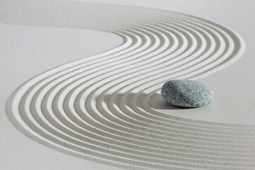 Japanese Zen garden with stone in textured sand