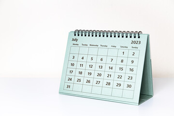 July 2023 calendar on white table. Month page