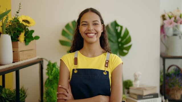 Young african american woman florist smiling confident standing with arms crossed gesture at flower shop