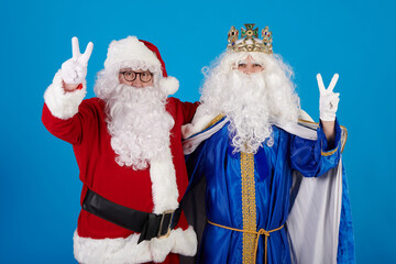 The Wise Man and Santa Claus making the symbol of victory