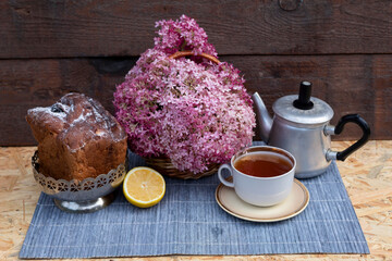 cup of tea and cake on wooden table
