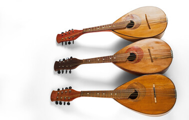 Three mandolins isolated on a white background. Baroque string musical instrument.