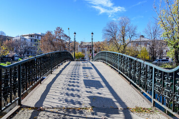 Fototapeta premium Old green metallic rusted bridge over Dambovita river in Bucharest, Romania, in a sunny autumn day