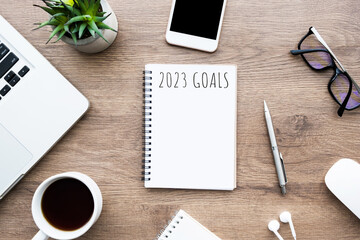 Notebook with 2023 goals text on it to apply new year resolutions and plan.