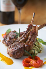 Two roasted lamb chops on a white plate