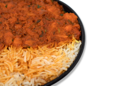 Traditional chicken dum briyani with boneless kebab combo closeup