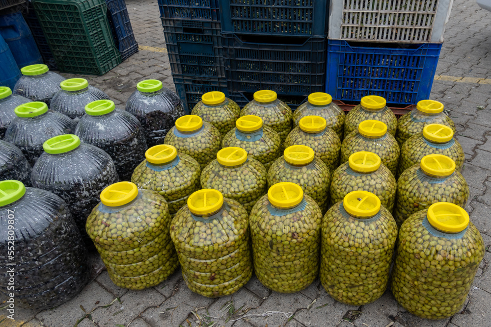 Wall mural fresh black olives in a plastic jar. olives on the sales counter ready for sale.