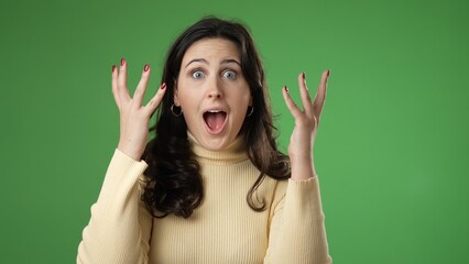 Portrait of excited, surprised smiling pretty young hipster woman 20s smiling isolated on green screen background studio