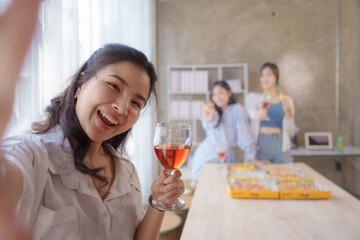 Selfie shot, Group of young asian office girl friends having fun and celebrating pizza on table during party