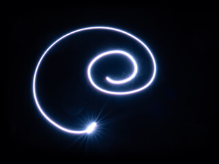 Magic blue light spirals on black background.