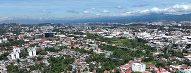 Naklejka premium Aerial view of La Sabana Park, Costa Rica National Stadium and San Jose, Costa Rica Skyline