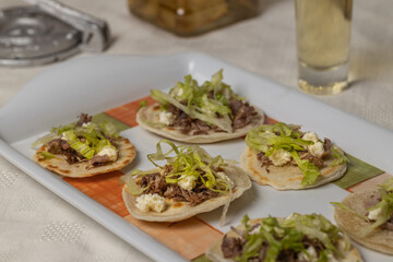 Close up of Chalupas, Typical Mexican dish made with tortillas, sauce, cheese, meat and lettuce.