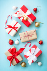 Christmas presents on blue background. Boxing day concept with holiday decorations. Top view with copy space.
