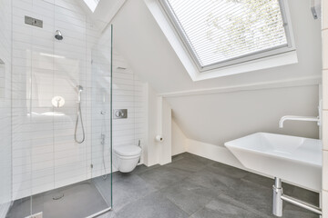 a modern bathroom with skylights and white tile flooring in an attic - style home, designed to look...