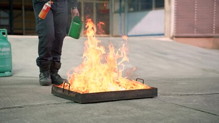 Man teaches or training how to use carbon dioxide (CO2) fire extinguishers to extinguish fires from fuel in house or industry for safety.