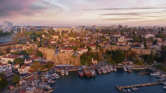 Panorama of the historic city on the seashore. Aerial video footage from a drone. Harbor with motorboat and sailboat.