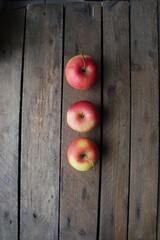 Ripe juicy apples on a wooden background.