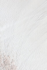 White volcanic limestone rock as background.