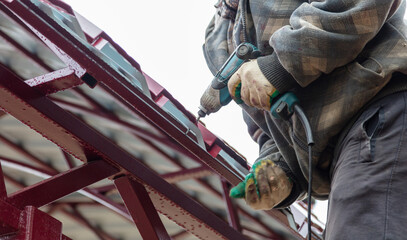 The worker sets the metal sheets on the weight.