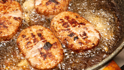 Cutlets are fried in oil in a frying pan.