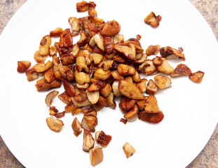 Fried mushrooms in a white plate on the table.