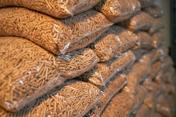 A massive stack of wooden pellets. Eco fuel for house heating. Sustainable and renewable energy for the better future concept.