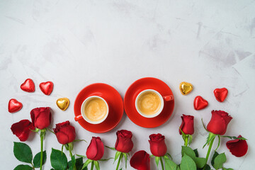 Valentine's day concept with coffee cups, heart shape chocolate and  rose flowers on bright background. Top view. Flat lay