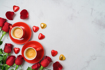 Valentine's day concept with coffee cups, heart shape chocolate and  rose flowers on bright...