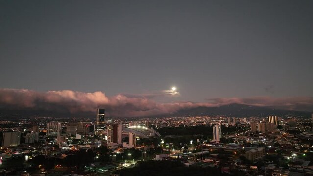 Aerial view of La Sabana Park and Costa Rica National Stadium with San Jose, Costa Rica in the background. Moonrise over the city