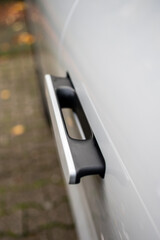 Electrically retractable car door handle from the outside on an electric car