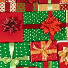 Holiday gift packages, wrapped with ribbons and bows. Background with colorful decorated gift boxes.