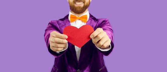 Crop close up banner shot of smiling man on purple studio background greet congratulate with...