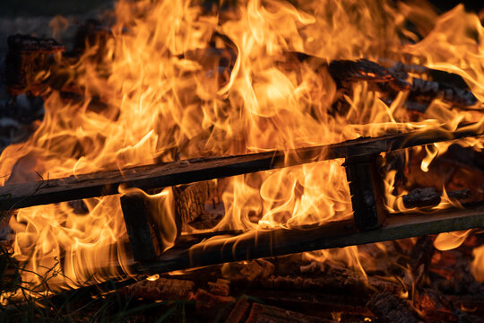 Flames Swirling Around Burning Wood