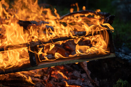 Flames Swirling Around Burning Wood