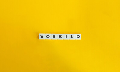 VORBILD (Model or Example in German). Block Letter Tiles on Yellow Background. Minimal Aesthetics.