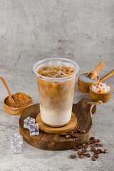 Boba or tapioca pearls is taiwan bubble milk tea in plastic cup with coffee flavor on texture  background, summers refreshment.