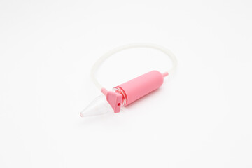 Pink aspirator. Medical item to suck discharge from the nose of an infant on a white background