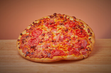 Meat feast pizza isolated on a gradient background.