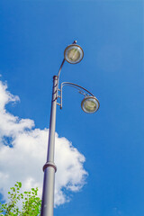 Fototapeta premium Street lamp close-up against the blue sky in summer.